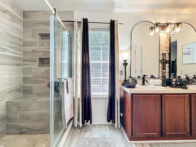 725 Ashworth Overlook Dr Unit C, Apopka, FL 32712 - full bathroom with a stall shower, double vanity, and wood finished floors