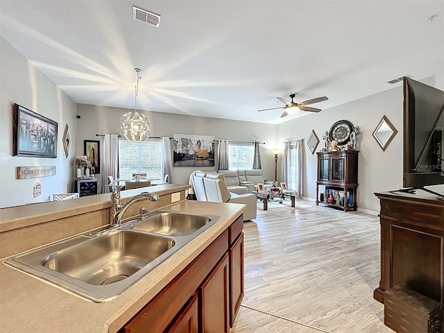 725 Ashworth Overlook Dr Unit C, Apopka, FL 32712 - kitchen featuring pendant lighting, ceiling fan, light countertops, a chandelier, and light wood finished floors