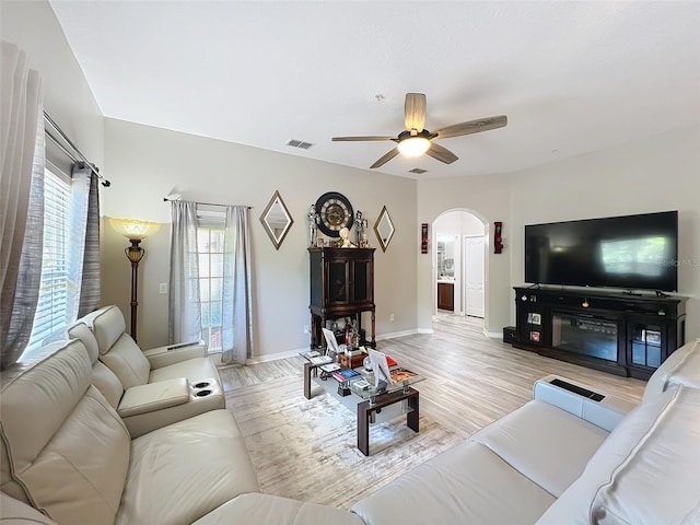 725 Ashworth Overlook Dr Unit C, Apopka, FL 32712 - living room featuring arched walkways, ceiling fan, and light wood-type flooring