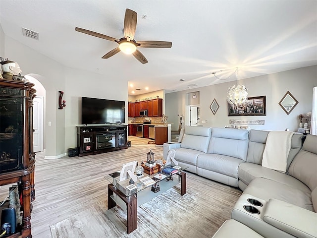 725 Ashworth Overlook Dr Unit C, Apopka, FL 32712 - living room with arched walkways, a ceiling fan, light wood-type flooring, and a chandelier