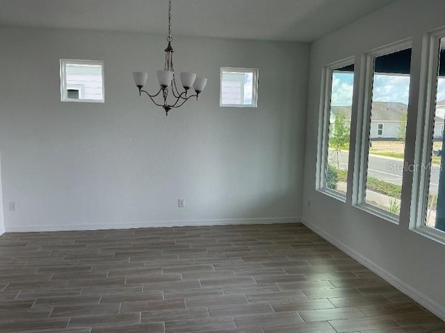 2971 Embark Trl, Saint Cloud, FL 34771 - unfurnished dining area featuring wood finished floors and a chandelier