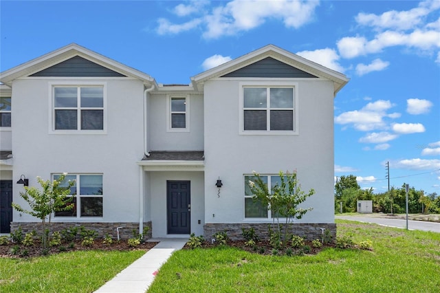 5645 Brosnan Rd, Saint Cloud, FL 34771 - view of property featuring stucco siding, a front yard, and stone siding
