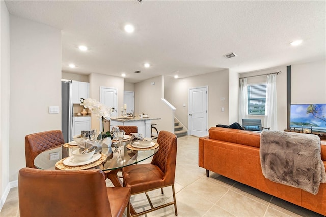 5645 Brosnan Rd, Saint Cloud, FL 34771 - dining area with stairs, recessed lighting, light tile patterned floors, and a textured ceiling