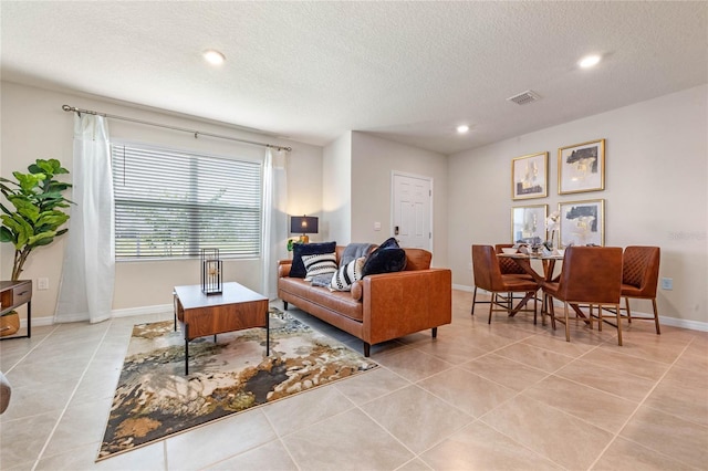 5645 Brosnan Rd, Saint Cloud, FL 34771 - living room featuring light tile patterned floors, a textured ceiling, and recessed lighting