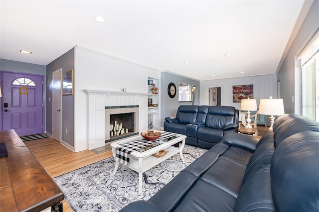 1301 Fahnstock St, Eustis, FL 32726 - living room featuring light wood-type flooring, a fireplace, ornamental molding, recessed lighting, and built in shelves