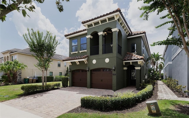 1156 Castle Pines Ct, Reunion, FL 34747 - mediterranean / spanish house with a tiled roof, an attached garage, stucco siding, and decorative driveway