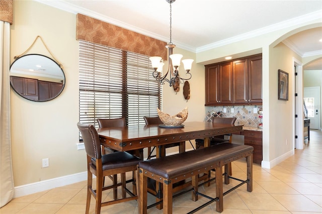 1156 Castle Pines Ct, Reunion, FL 34747 - dining area with arched walkways, a chandelier, light tile patterned floors, and ornamental molding