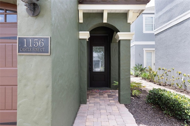 1156 Castle Pines Ct, Reunion, FL 34747 - entrance to property with stucco siding