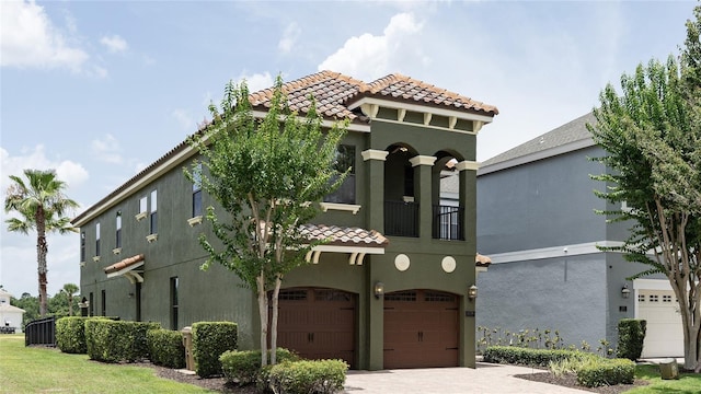 1156 Castle Pines Ct, Reunion, FL 34747 - view of front facade with a tiled roof, an attached garage, and stucco siding