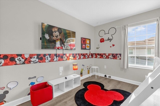 4802 Lullaby Ln, Kissimmee, FL 34746 - recreation room featuring wood finished floors and baseboards