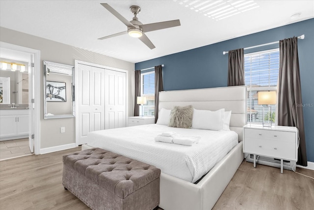 4802 Lullaby Ln, Kissimmee, FL 34746 - bedroom with wood finished floors, a closet, ensuite bath, and a ceiling fan