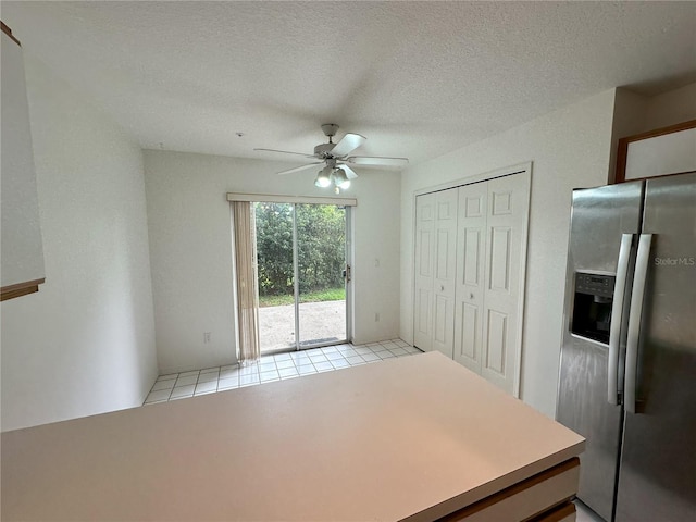 3352 Hamlet Loop, Winter Park, FL 32792 - kitchen with stainless steel fridge with ice dispenser, a ceiling fan, light tile patterned flooring, and a textured ceiling