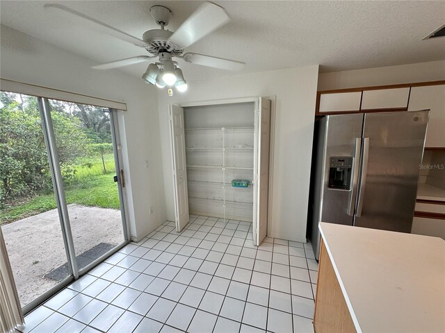3352 Hamlet Loop, Winter Park, FL 32792 - unfurnished dining area featuring a ceiling fan, light tile patterned floors, and a textured ceiling