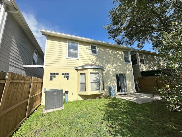3352 Hamlet Loop, Winter Park, FL 32792 - back of property with a fenced backyard, stucco siding, and a patio area