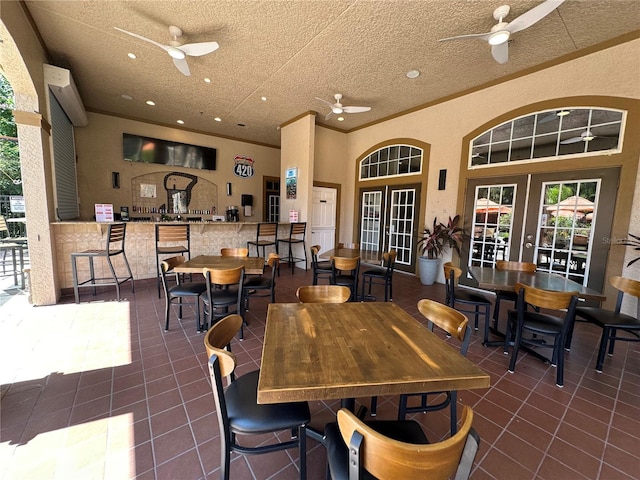 1370 Tuscan Ter Unit 2202, Davenport, FL 33896 - view of patio / terrace featuring a ceiling fan, french doors, exterior bar, and outdoor dining area