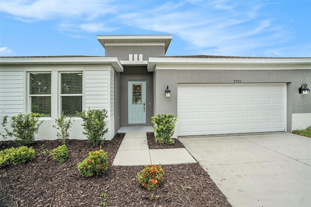 9955 Patrician Dr, New Port Richey, FL 34655 - view of front of house featuring concrete driveway, stucco siding, and an attached garage
