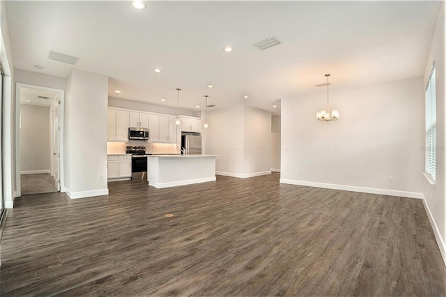 9955 Patrician Dr, New Port Richey, FL 34655 - unfurnished living room with dark wood-type flooring, a chandelier, and recessed lighting