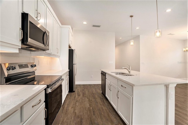 9955 Patrician Dr, New Port Richey, FL 34655 - kitchen featuring appliances with stainless steel finishes, dark wood-style flooring, tasteful backsplash, white cabinets, and recessed lighting