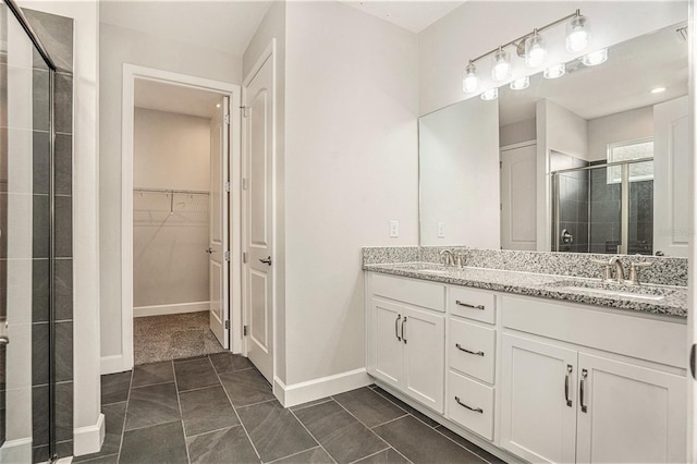 9955 Patrician Dr, New Port Richey, FL 34655 - full bathroom featuring a stall shower, double vanity, a spacious closet, and tile patterned flooring