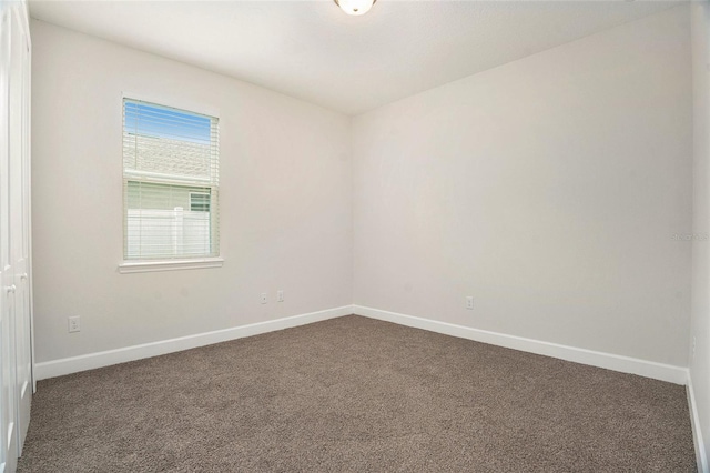 9955 Patrician Dr, New Port Richey, FL 34655 - spare room featuring dark carpet
