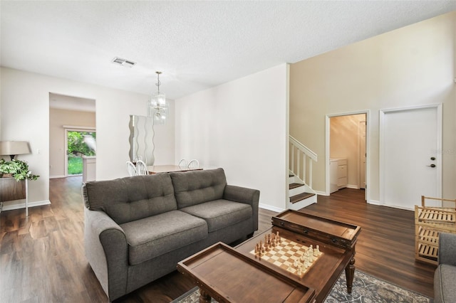 1936 Westpointe Cir, Orlando, FL 32835 - living area with wood finished floors, stairs, a chandelier, and a textured ceiling