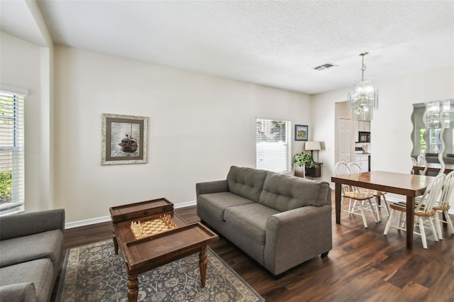 1936 Westpointe Cir, Orlando, FL 32835 - living room with healthy amount of natural light, dark wood-type flooring, a chandelier, and a textured ceiling