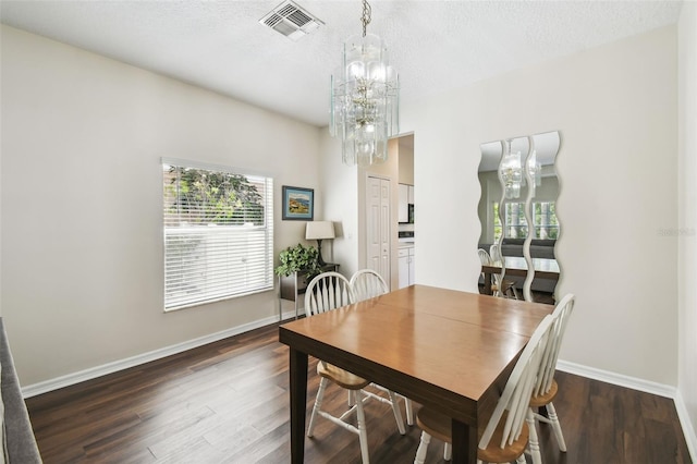 1936 Westpointe Cir, Orlando, FL 32835 - dining area featuring wood finished floors, a chandelier, and a textured ceiling