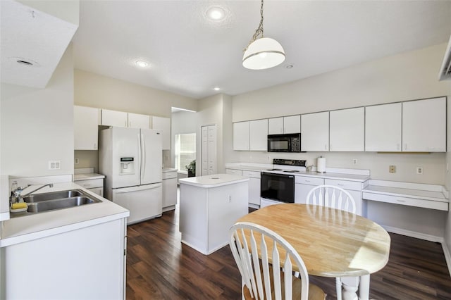 1936 Westpointe Cir, Orlando, FL 32835 - kitchen featuring white appliances, light countertops, white cabinets, dark wood finished floors, and recessed lighting