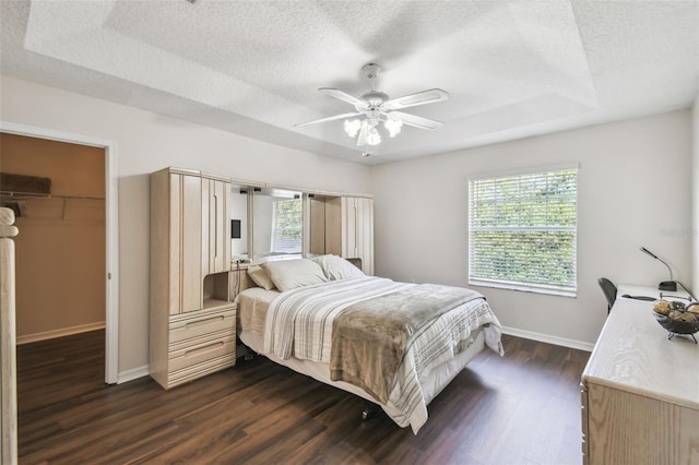 1936 Westpointe Cir, Orlando, FL 32835 - bedroom featuring a spacious closet, dark wood-style flooring, a textured ceiling, ceiling fan, and a closet