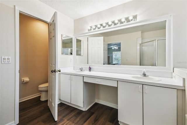 1936 Westpointe Cir, Orlando, FL 32835 - bathroom featuring double vanity, wood finished floors, a stall shower, and a textured ceiling