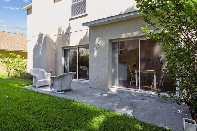 1936 Westpointe Cir, Orlando, FL 32835 - back of property featuring a patio, stucco siding, and a lawn