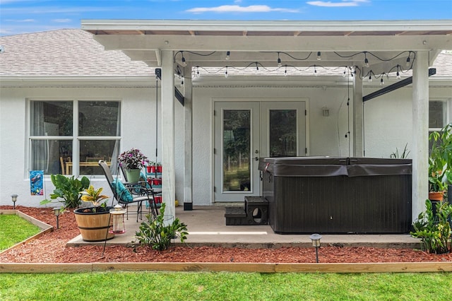 15364 Mount Sparrow Rd, Weeki Wachee, FL 34614 - view of exterior entry featuring roof with shingles, a hot tub, and stucco siding