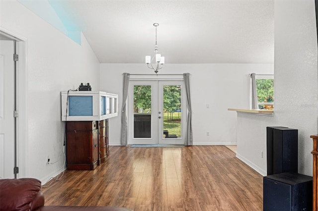 15364 Mount Sparrow Rd, Weeki Wachee, FL 34614 - living area with wood finished floors, lofted ceiling, french doors, and a chandelier