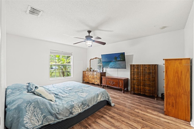 15364 Mount Sparrow Rd, Weeki Wachee, FL 34614 - bedroom with wood finished floors, a ceiling fan, and a textured ceiling