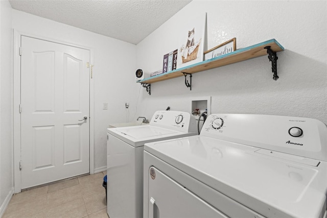 15364 Mount Sparrow Rd, Weeki Wachee, FL 34614 - laundry room featuring independent washer and dryer, a textured ceiling, and light tile patterned floors