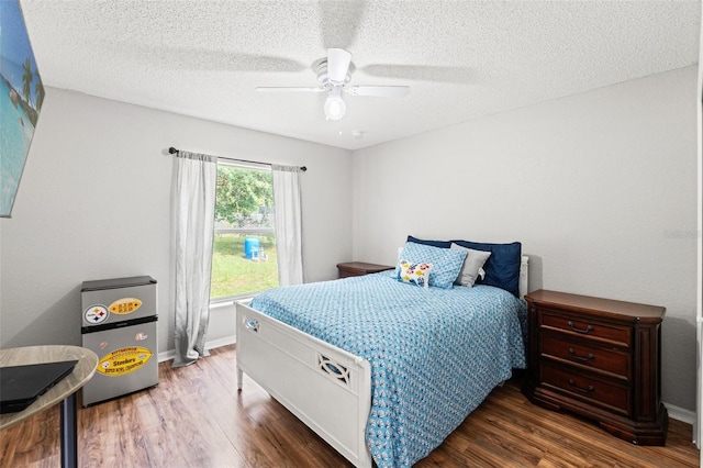15364 Mount Sparrow Rd, Weeki Wachee, FL 34614 - bedroom featuring wood finished floors, a textured ceiling, and ceiling fan