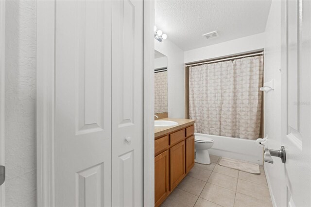15364 Mount Sparrow Rd, Weeki Wachee, FL 34614 - full bathroom with vanity, shower / bathtub combination with curtain, tile patterned floors, and a textured ceiling