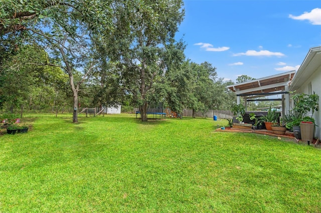 15364 Mount Sparrow Rd, Weeki Wachee, FL 34614 - fenced backyard with a trampoline