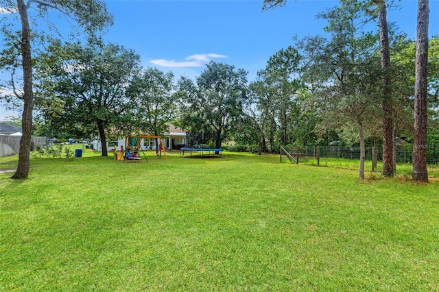 15364 Mount Sparrow Rd, Weeki Wachee, FL 34614 - view of yard with a trampoline and a playground