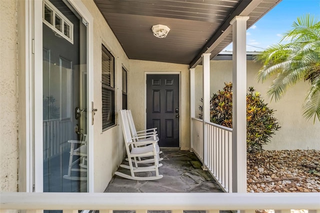 4130 W Main St, Mims, FL 32754 - view of exterior entry featuring stucco siding and a porch