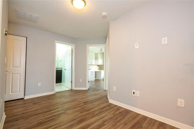 11081 Savannah Landing Cir, Orlando, FL 32832 - empty room featuring a smoke detector and wood finished floors