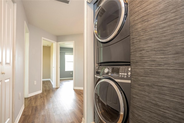 11081 Savannah Landing Cir, Orlando, FL 32832 - laundry area with stacked washer and clothes dryer and wood finished floors