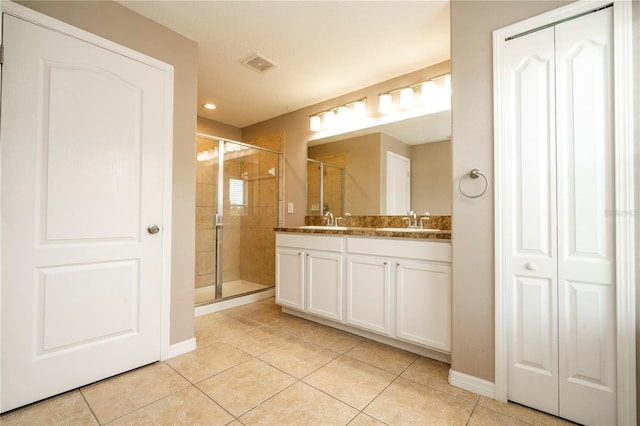 11081 Savannah Landing Cir, Orlando, FL 32832 - bathroom featuring tile patterned flooring, double vanity, a stall shower, a closet, and recessed lighting