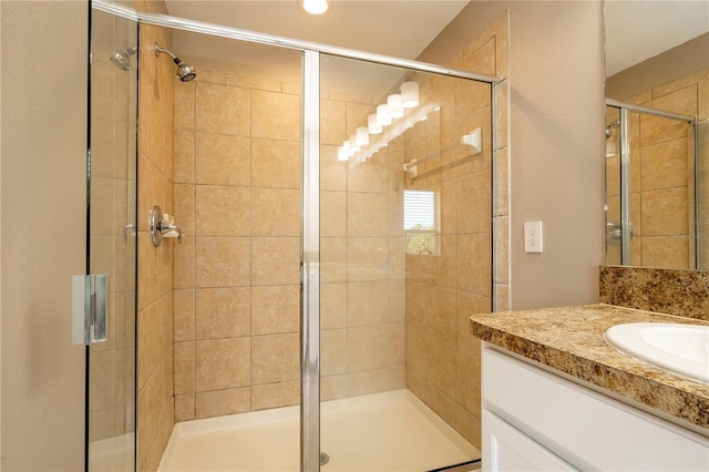11081 Savannah Landing Cir, Orlando, FL 32832 - full bathroom with vanity, a shower stall, and a textured wall