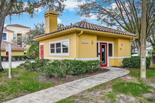 1275 Lake Shadow Cir Unit 13106, Maitland, FL 32751 - view of front of property featuring a chimney, stucco siding, and a tiled roof