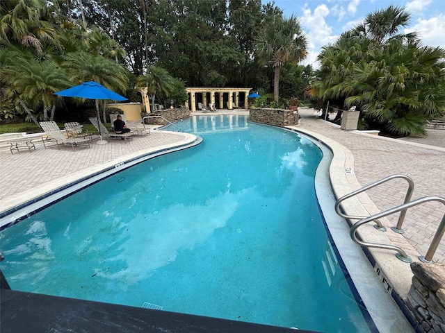 1275 Lake Shadow Cir Unit 13106, Maitland, FL 32751 - community pool featuring a patio area and view of scattered trees