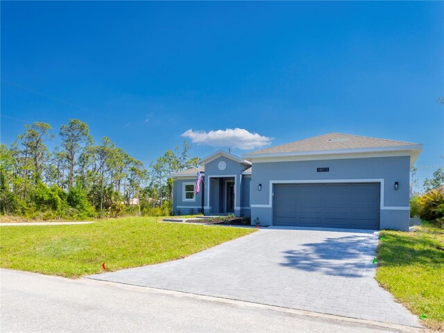 14073 Naylor Ave, Port Charlotte, FL 33981 - ranch-style home featuring stucco siding, a front yard, an attached garage, and decorative driveway