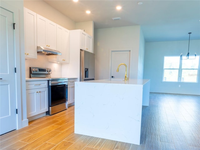 14073 Naylor Ave, Port Charlotte, FL 33981 - kitchen featuring stainless steel appliances, under cabinet range hood, light wood-type flooring, light countertops, and recessed lighting