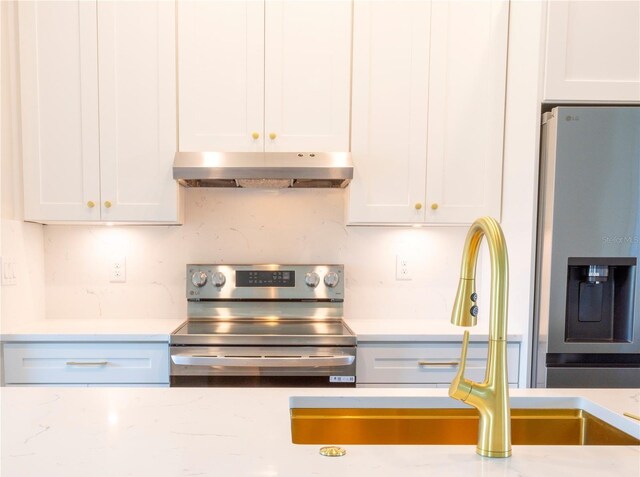 14073 Naylor Ave, Port Charlotte, FL 33981 - kitchen featuring stainless steel appliances, under cabinet range hood, and white cabinets