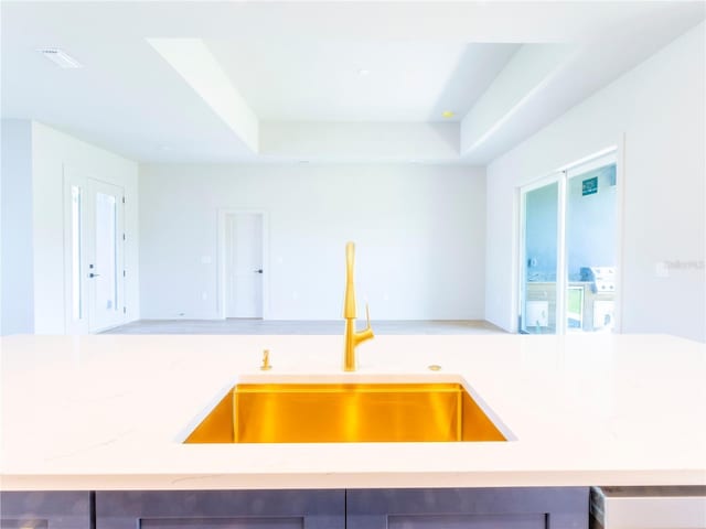 14073 Naylor Ave, Port Charlotte, FL 33981 - kitchen featuring a raised ceiling, light stone countertops, and open floor plan